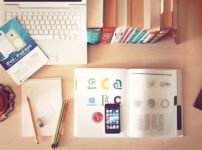 pencils and smartphone on top of books